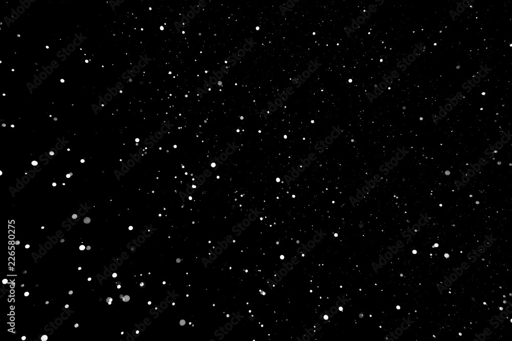 Snowflakes in the night sky on a black background