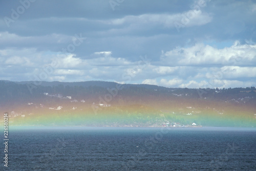 Rainbow just above the water. © oleksandr