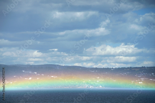 Scandinavian landscape with fjordand rainbow. © oleksandr
