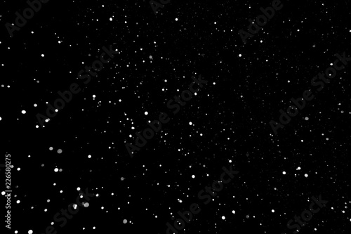 Snowflakes in the night sky on a black background