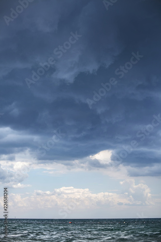 bad weather, a storm begins on the sea, dark blue clouds hang in the sky