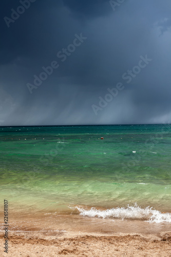 Fototapeta Naklejka Na Ścianę i Meble -  bad weather, a storm begins on the sea, dark blue clouds hang in the sky,coastline, wave, splash
