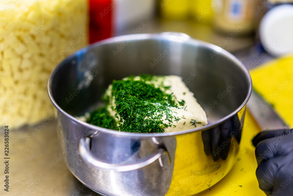 Cutted Dill on Top of The Butter in the Steel Pot