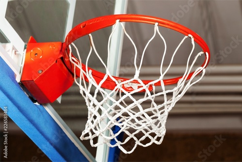 Adidas Basketball ball hitting basket in gym © BillionPhotos.com
