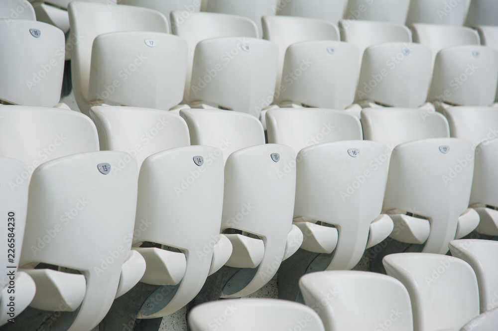 Naklejka premium Empty white seats in stadium