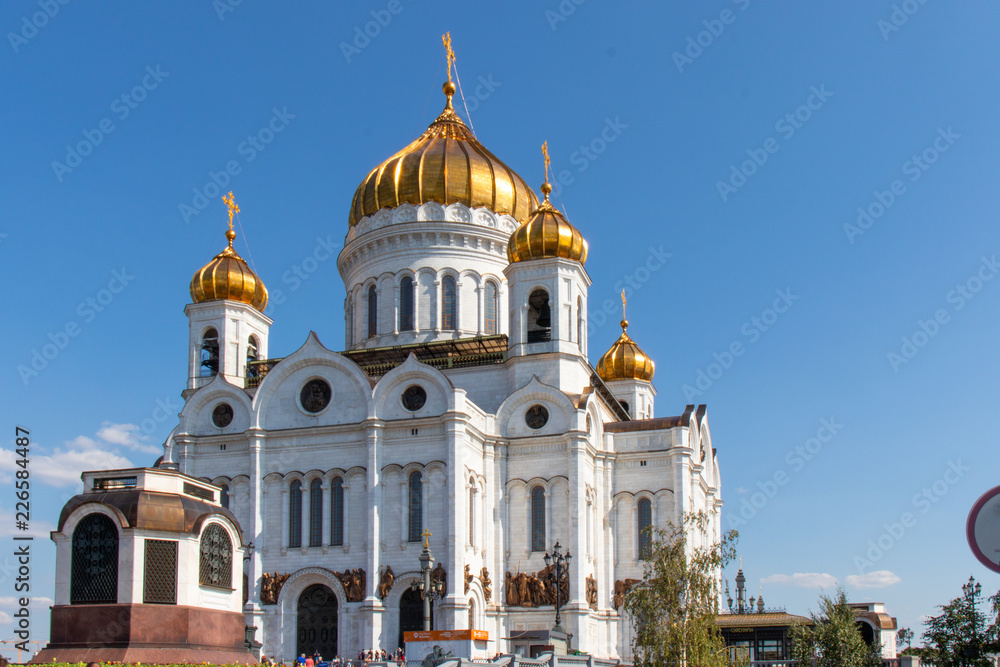 Christ the Savior Cathedral with golden domes against the blue sky. Christ Church in Moscow. Golden domes, blue sky.