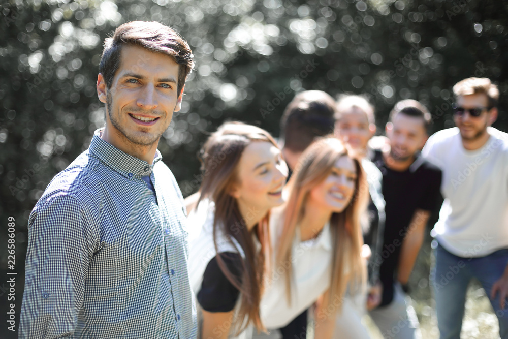 modern guy on the background of his friends. modern guy on the background of his friends.