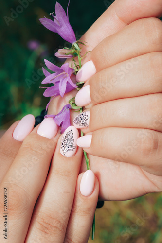 beautiful manicure close-up with a purple flower