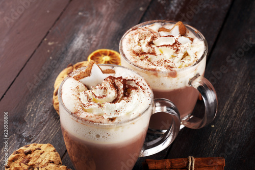 Hot chocolate cocoa with whipped cream on table.