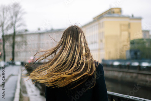 Girl with long hair in the winter windy city