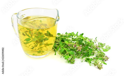 Fresh Wild Thyme Tea in a Glass with a Bunch of Thyme Herb. Also Tymus Vulgaris, Common, German or Garden Thyme, Isolated on White Background.
