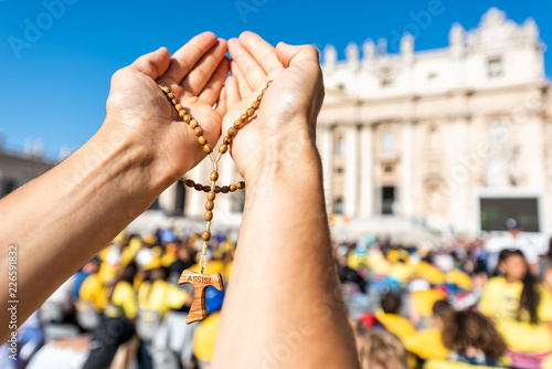 Photography Macro closeup of hands holding wooden handmade Italian cross Catholic Assisi ros