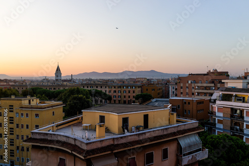 Cityscape of Rome, Italy historic city with church tower bell, summer evening sunset night skyline, mountain aerial view of urban rooftops photo