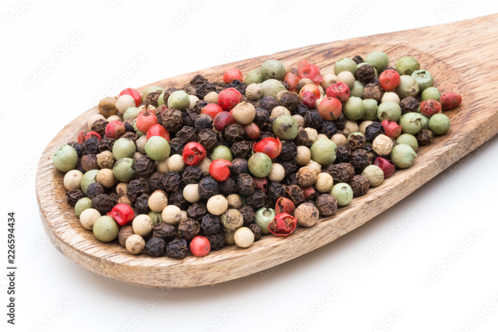 Pepper mix seed on spoon on white background. Pepper mix seed on spoon on white background.