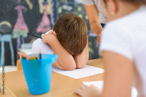 Foto Cute boy is not happy at kindergarten