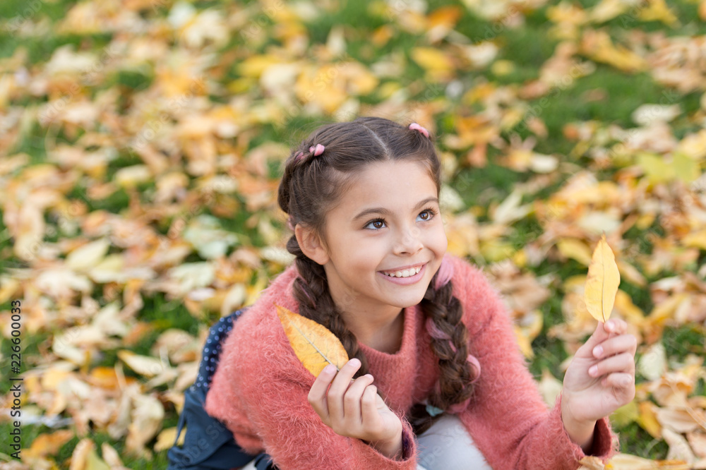 Happy childhood. School time. Happy little girl in autumn forest. Small child with autumn leaves. Autumn leaves and nature. So beautiful. Feeling free and relaxed. Good mood at any weather Happy childhood. School time. Happy little girl in autumn forest. Small child with autumn leaves. Autumn leaves and nature. So beautiful. Feeling free and relaxed. Good mood at any weather