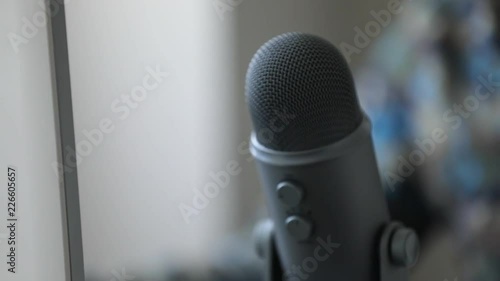 Slo-Motion Pan Shot Of Pro Microphone and PC Monitor On Modern Desk