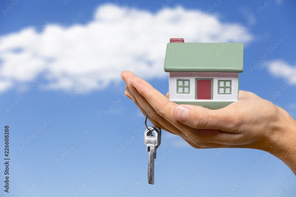 Naklejka premium Businessman Holding House Model and Keys