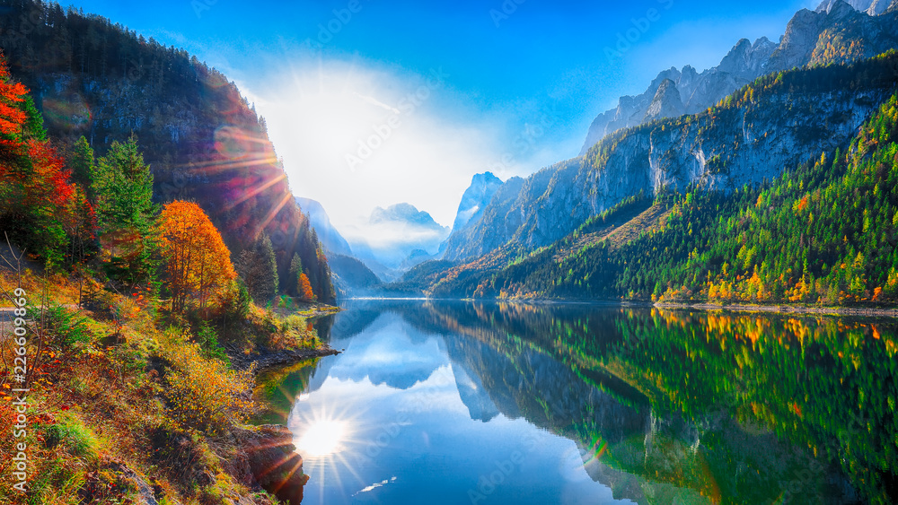 Naklejka premium autumn scenery with Dachstein mountain summit reflecting in crystal clear Gosausee mountain lake