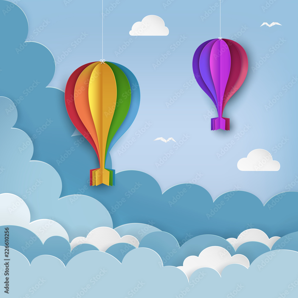Obraz premium Hanging paper craft hot air balloons, flying birds, clouds on the daytime sky background. Cloudy sky background. Minimal summertime scene. Paper hot air balloon garland with bows. Vector Illustration.