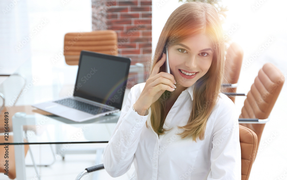 closeup.female assistant talking on mobile phone in office closeup.female assistant talking on mobile phone in office
