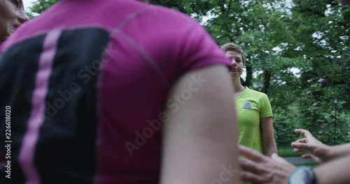 A group of young friends with healthy lifestyle resting and treching outdoors photo