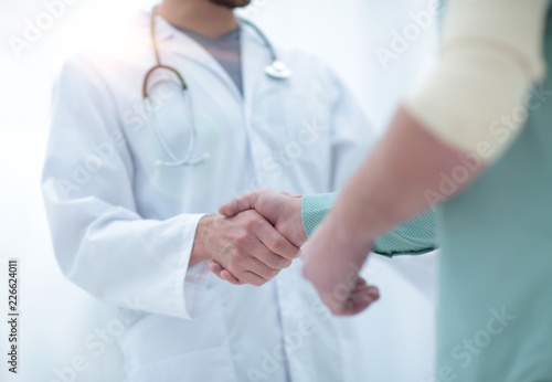 patient shakes hands with his physician photo