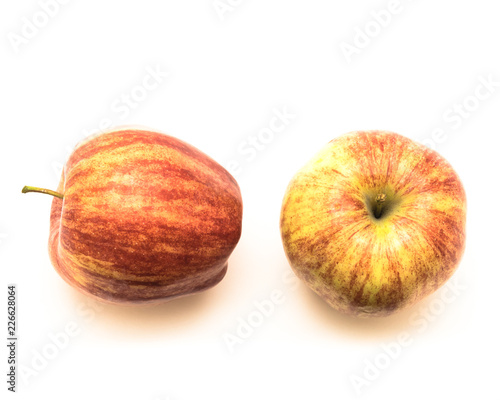 Studio shot top view two fresh raw organic gala apples isolated on white background. Vertically striped, mottled, and overall orange in color skin. Sweet, fine textured, and aromatic flavor photo