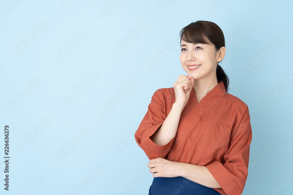 portrait of japanese style waitress isolated on blue background portrait of japanese style waitress isolated on blue background