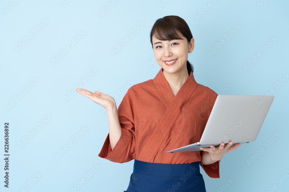 portrait of japanese style waitress isolated on blue background portrait of japanese style waitress isolated on blue background