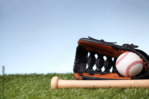 Baseball equipment on green grass