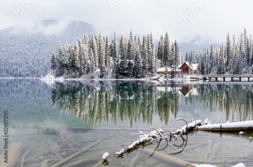 Fresh Snowfall on Cottage on Mountain Lake