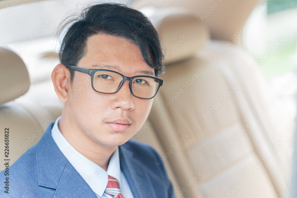 Businessman sit in the backseat of a car Businessman sit in the backseat of a car