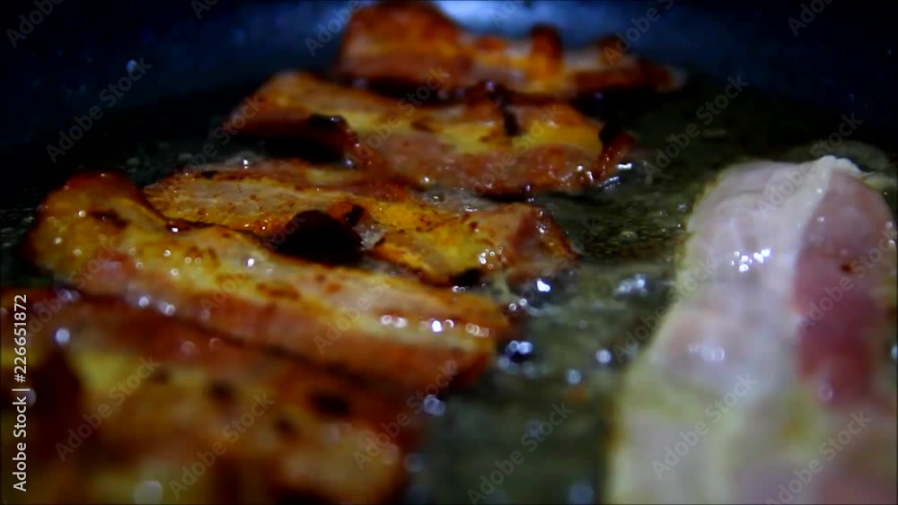 Close up video of fried bacon in a pan Close up video of fried bacon in a pan