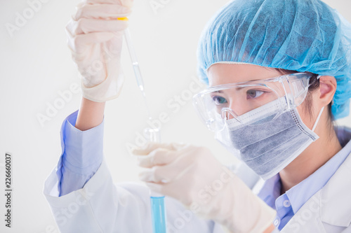 Fototapeta Naklejka Na Ścianę i Meble -  woman scientist take test tube