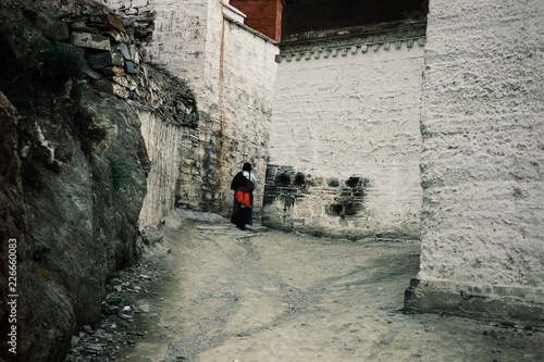 tibetan buddhist pilgrim woman doing her walk around the monastery