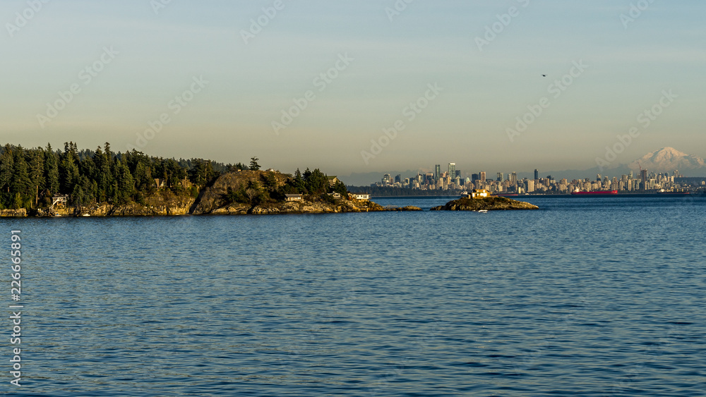 Downtown Vancouver, beautiful British Columbia, Canada, seen from the ferryboat, snowy peak of Mount Baker in the background.