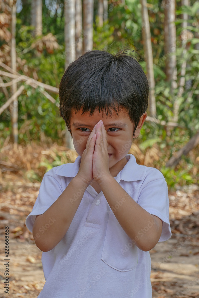 Boy put hands together in a prayer position Boy put hands together in a prayer position