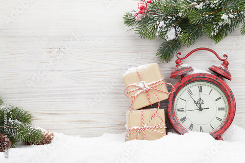 Christmas gift boxes, alarm clock and fir tree