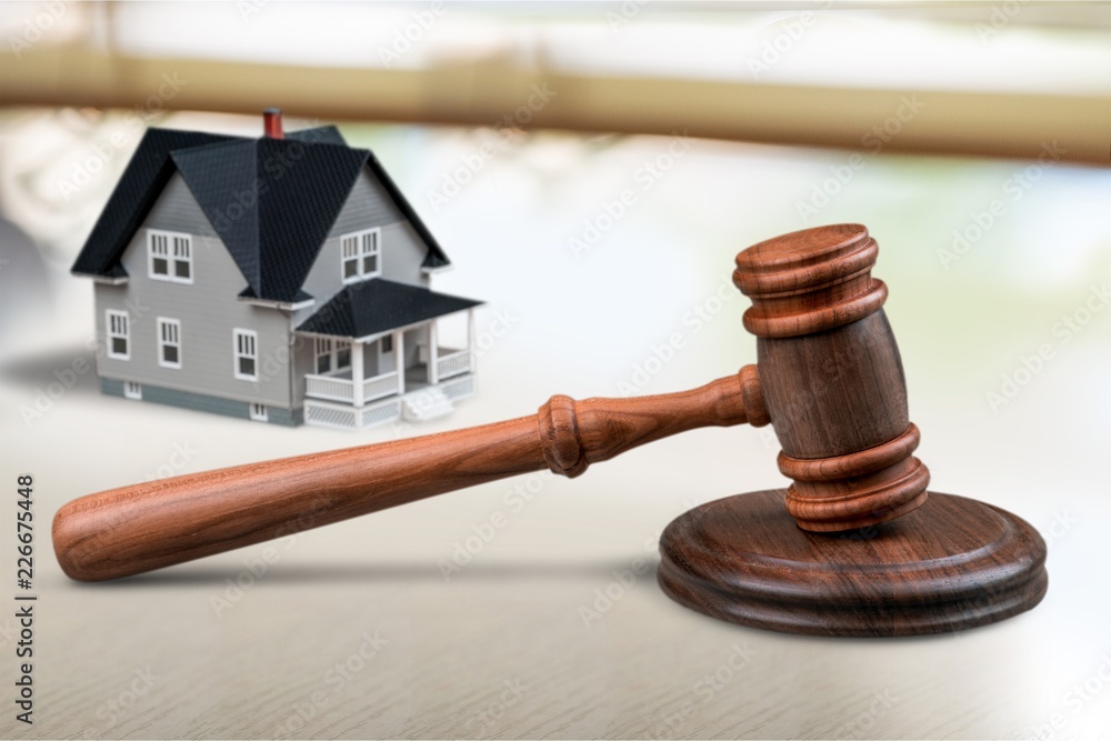 Wooden judge gavel and toy house on Wooden judge gavel and toy house on