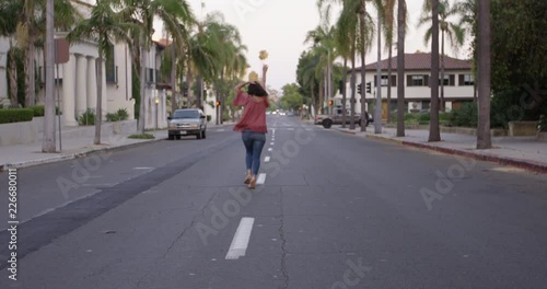 Wallpaper Mural Beautiful young woman traveller running down California street - wide shot - standard speed Torontodigital.ca