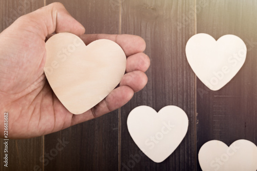 Beautiful paper hearts on wood background