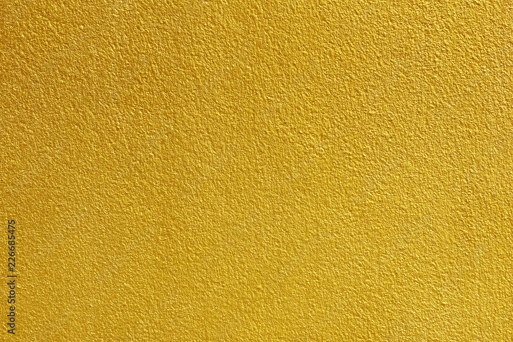Gold paint on rough cement wall texture background Gold paint on rough cement wall texture background