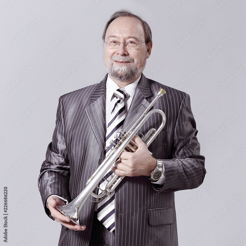 Fototapeta premium man in a gray suit with a trumpet