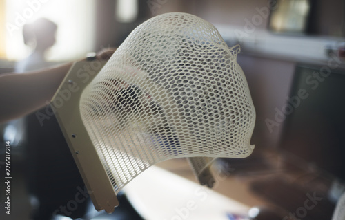 A mask for treating a patient with a brain tumor. Technology is a gamma knife.