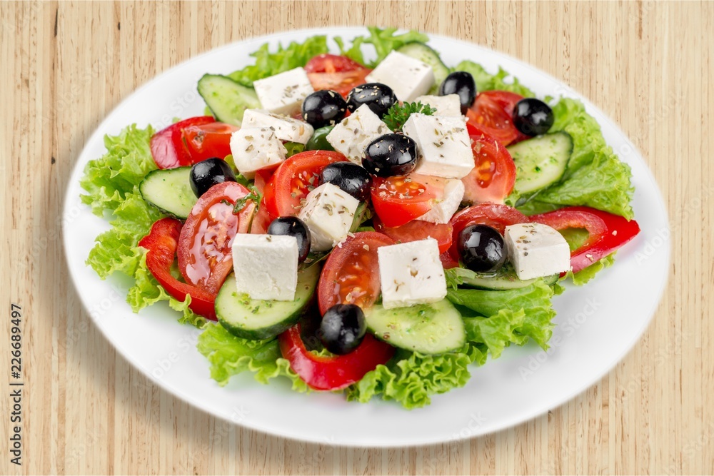 Greek salad with fresh vegetables on background Greek salad with fresh vegetables on background