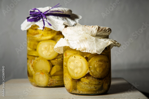 two small glass jars with homemade canned sliced zucchini
