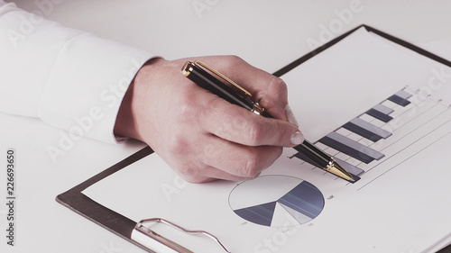 closeup.business woman checking marketing graphics. isolated on white.