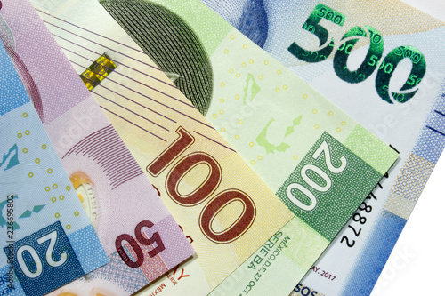 Arrangement of assorted mexican peso bills.