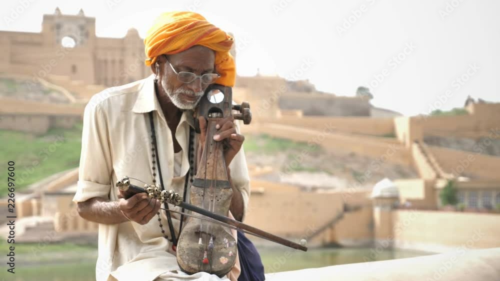 An Old traditional man playing Sarangi (An String instrument) against ...